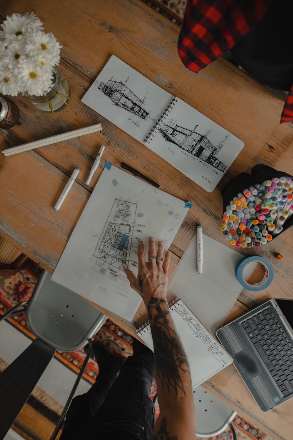Architecture sketches, markers, and design materials on a work table