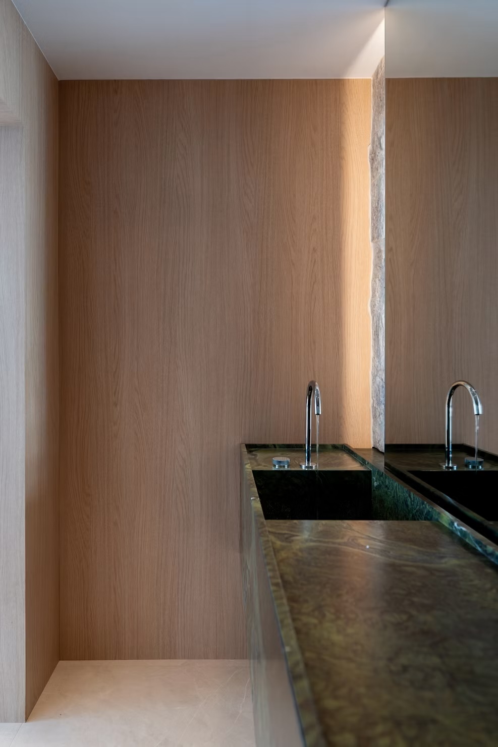 Wood-paneled interior with stone counter and chrome fixtures